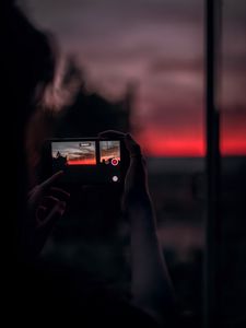 Preview wallpaper phone, shooting, hands, sunset, dark