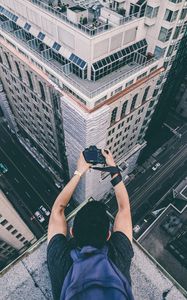 Preview wallpaper photographer, camera, buildings, height