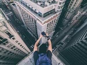 Preview wallpaper photographer, camera, buildings, height