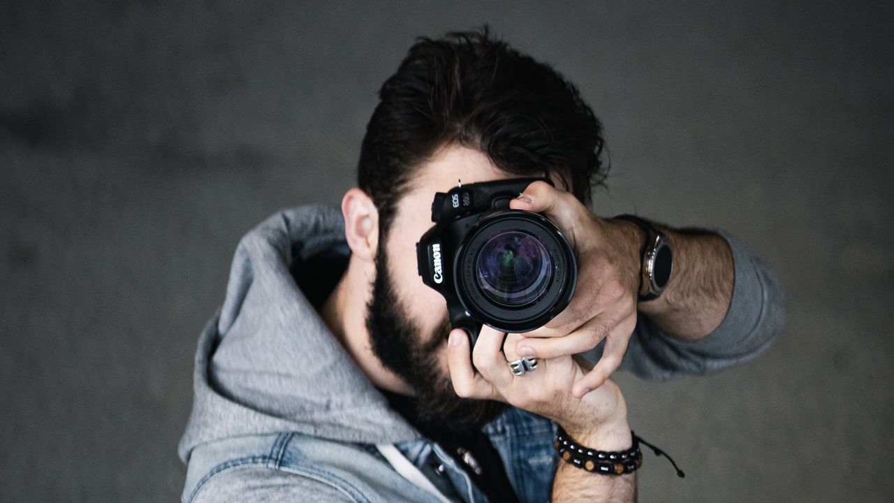 Photographer Looking at a Viewfinder · Free Stock Photo