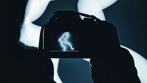 Preview wallpaper photographer, camera, rabbit, neon, dark