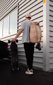Preview wallpaper photographer, camera, skateboard, style, cap
