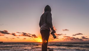 Preview wallpaper photographer, sea, sunset, stones, shore