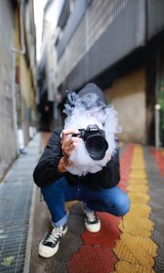 Preview wallpaper photographer, smoke, camera, hand