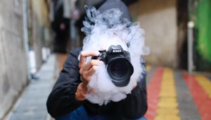 Preview wallpaper photographer, smoke, camera, hand