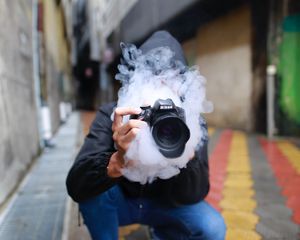 Preview wallpaper photographer, smoke, camera, hand