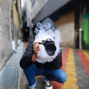 Preview wallpaper photographer, smoke, camera, hand