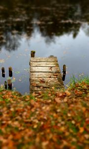 Preview wallpaper pier, autumn, river, fallen leaves