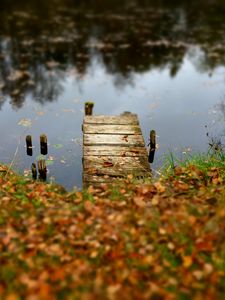 Preview wallpaper pier, autumn, river, fallen leaves