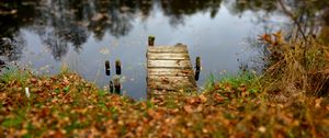 Preview wallpaper pier, autumn, river, fallen leaves