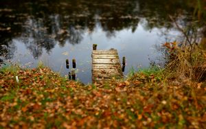 Preview wallpaper pier, autumn, river, fallen leaves