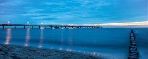 Preview wallpaper pier, beach, sunset, sea, coast, sand, horizon