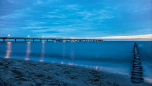 Preview wallpaper pier, beach, sunset, sea, coast, sand, horizon