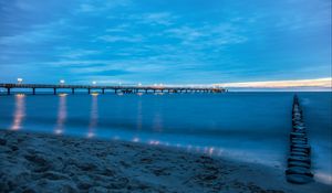 Preview wallpaper pier, beach, sunset, sea, coast, sand, horizon