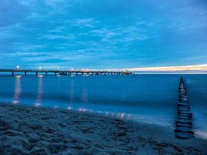 Preview wallpaper pier, beach, sunset, sea, coast, sand, horizon