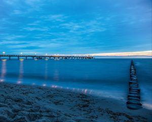 Preview wallpaper pier, beach, sunset, sea, coast, sand, horizon