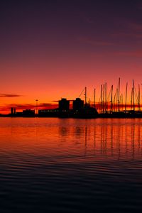 Preview wallpaper pier, buildings, boats, silhouettes, water, sunset, dark