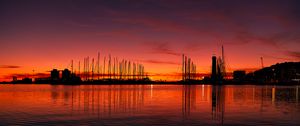 Preview wallpaper pier, buildings, boats, silhouettes, water, sunset, dark