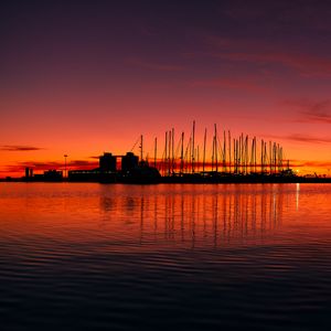 Preview wallpaper pier, buildings, boats, silhouettes, water, sunset, dark