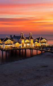 Preview wallpaper pier, buildings, lights, illumination, sea, beach