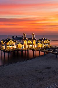 Preview wallpaper pier, buildings, lights, illumination, sea, beach