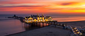 Preview wallpaper pier, buildings, lights, illumination, sea, beach