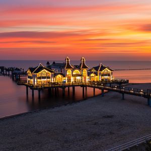 Preview wallpaper pier, buildings, lights, illumination, sea, beach