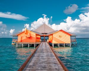 Preview wallpaper pier, buildings, ocean, coast, tropics