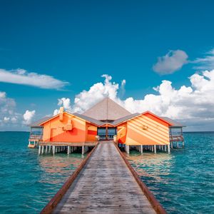 Preview wallpaper pier, buildings, ocean, coast, tropics