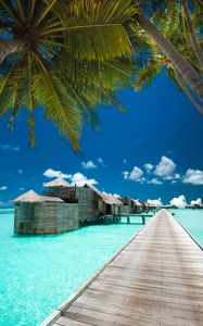 Preview wallpaper pier, bungalow, palm tree, sky, clouds