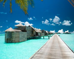 Preview wallpaper pier, bungalow, palm tree, sky, clouds