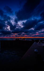 Preview wallpaper pier, clouds, sunset, ocean, horizon, dark