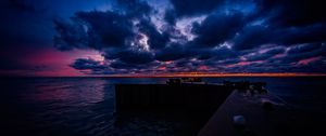 Preview wallpaper pier, clouds, sunset, ocean, horizon, dark