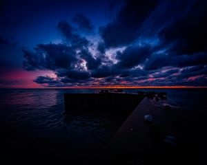 Preview wallpaper pier, clouds, sunset, ocean, horizon, dark