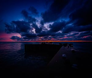 Preview wallpaper pier, clouds, sunset, ocean, horizon, dark