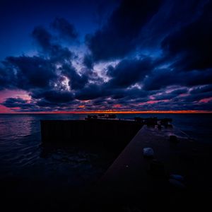 Preview wallpaper pier, clouds, sunset, ocean, horizon, dark