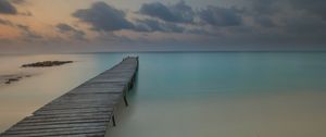 Preview wallpaper pier, coast, sand, horizon, clouds