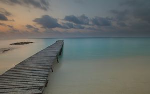 Preview wallpaper pier, coast, sand, horizon, clouds