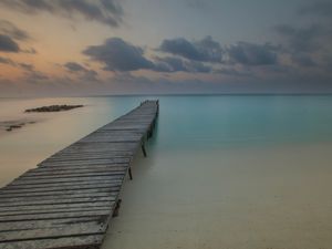Preview wallpaper pier, coast, sand, horizon, clouds