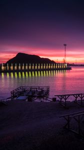 Preview wallpaper pier, coast, sunset, mountains, glow