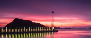 Preview wallpaper pier, coast, sunset, mountains, glow