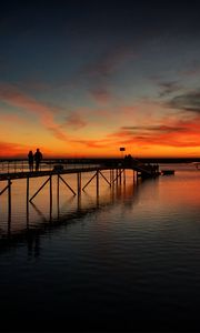 Preview wallpaper pier, couple, silhouettes, sea, evening