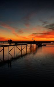 Preview wallpaper pier, couple, silhouettes, sea, evening