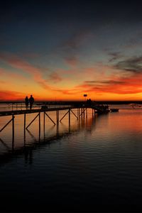 Preview wallpaper pier, couple, silhouettes, sea, evening