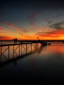 Preview wallpaper pier, couple, silhouettes, sea, evening