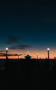 Preview wallpaper pier, dark, garlands, lights, silhouettes