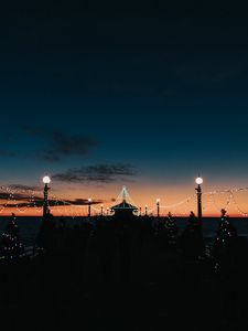 Preview wallpaper pier, dark, garlands, lights, silhouettes