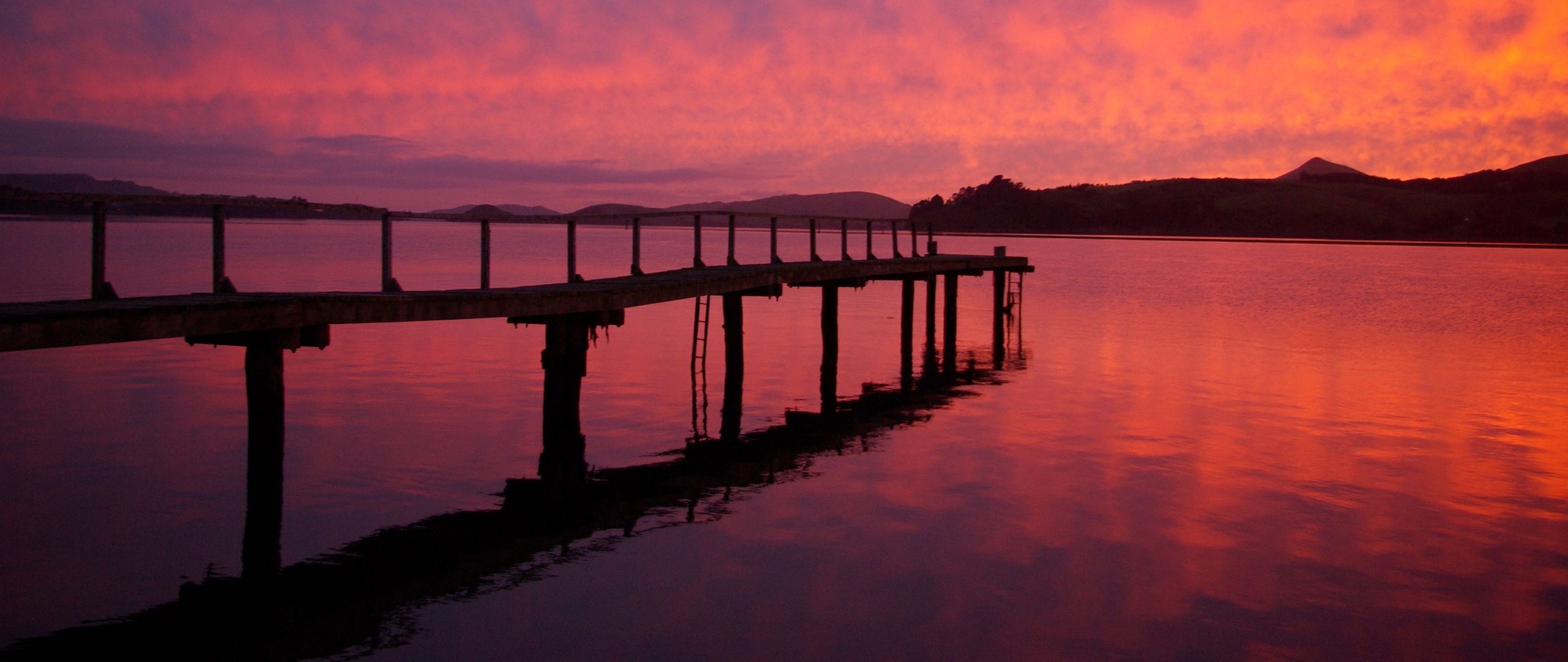 Download wallpaper 2560x1080 pier, lake, hills, evening dual wide 1080p