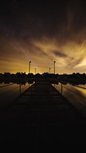 Preview wallpaper pier, lake, sunset, starry sky