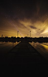 Preview wallpaper pier, lake, sunset, starry sky